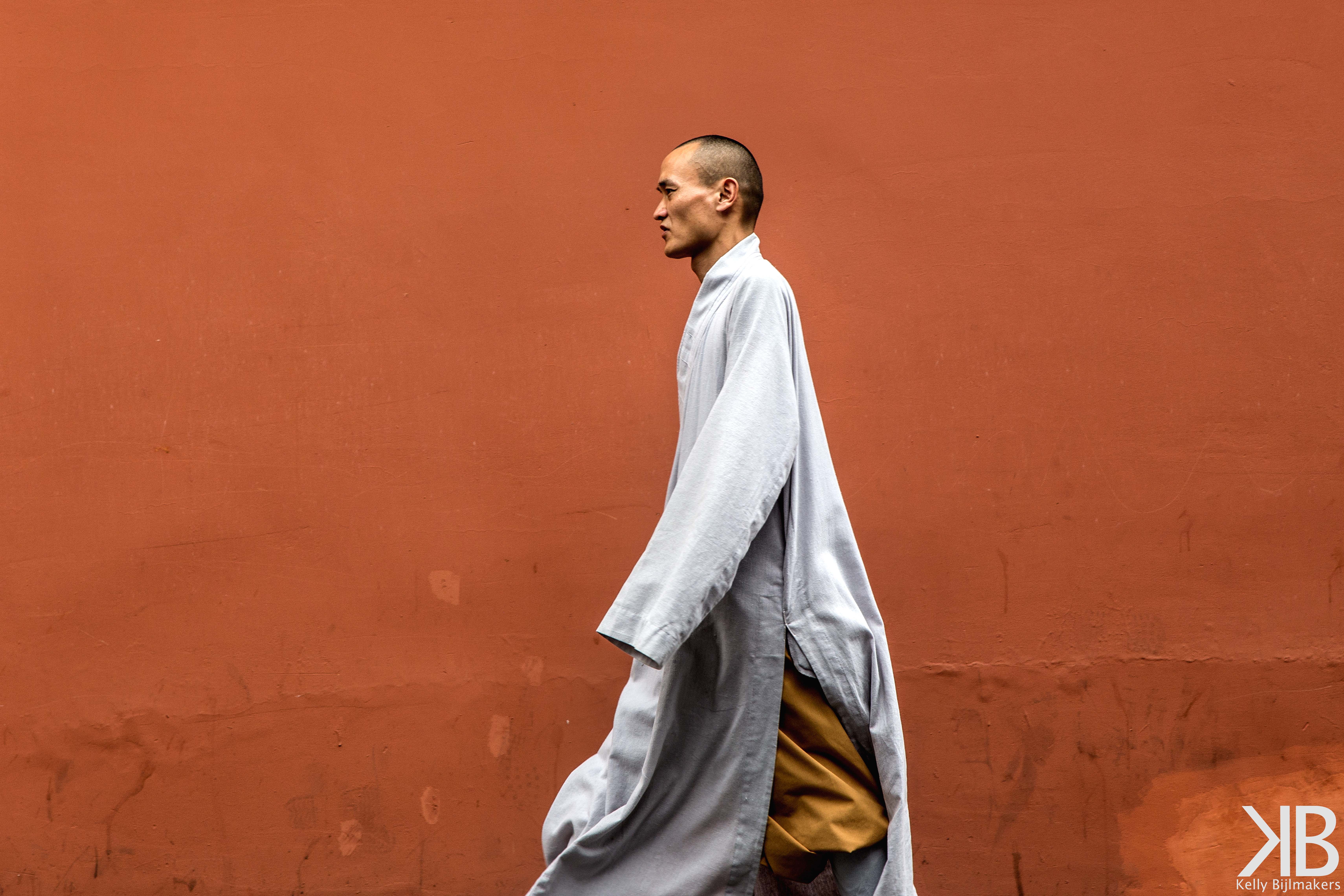 monk-in-front-of-red-wall