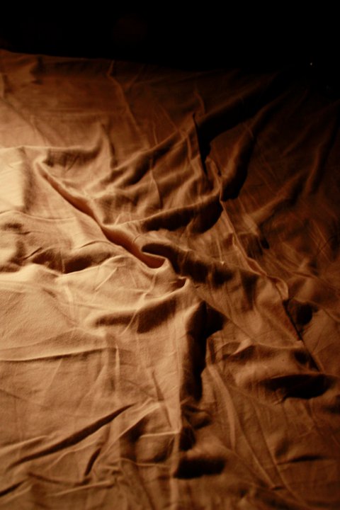 a-figure-cuffed-in-a-bedspread