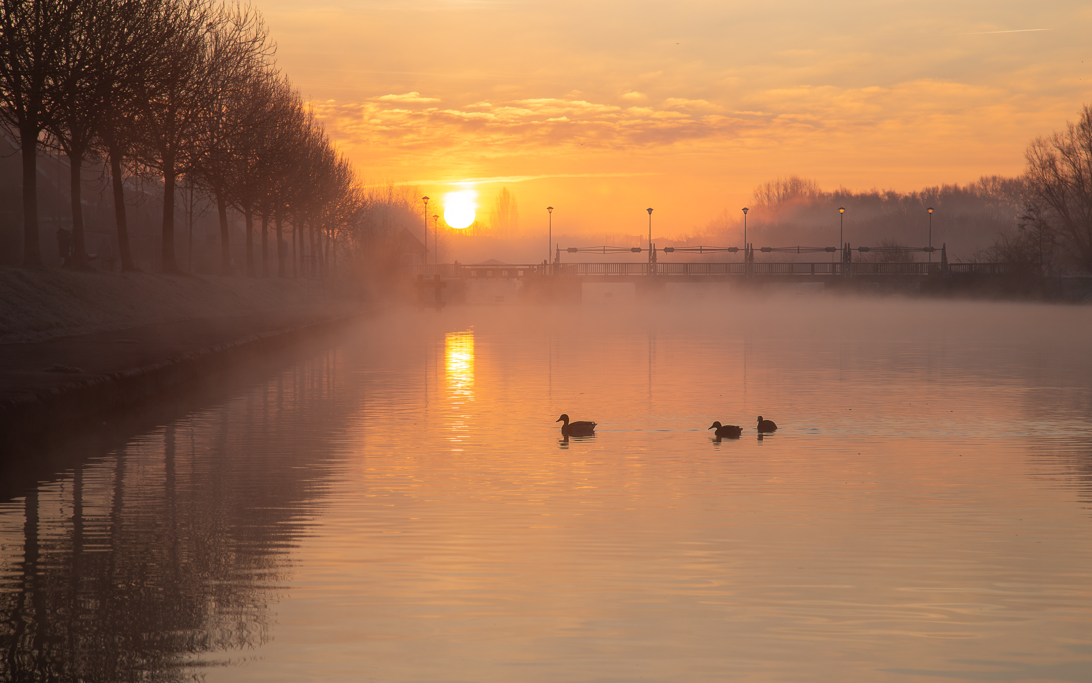zonsopkomst-boven-de-leie-in-menen-belgie