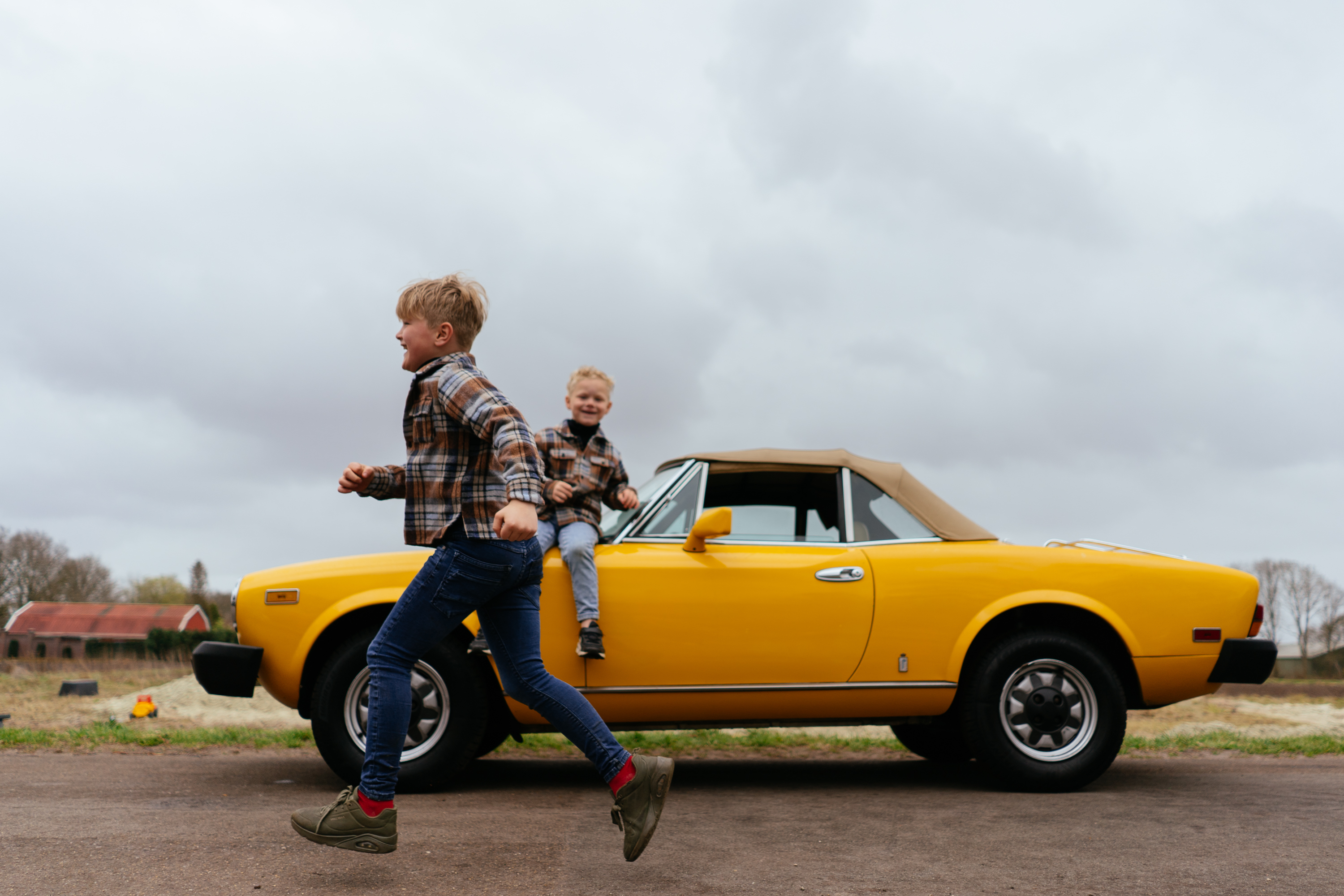 twee-buitenspeeljongens-en-een-erf-vol-met-autos